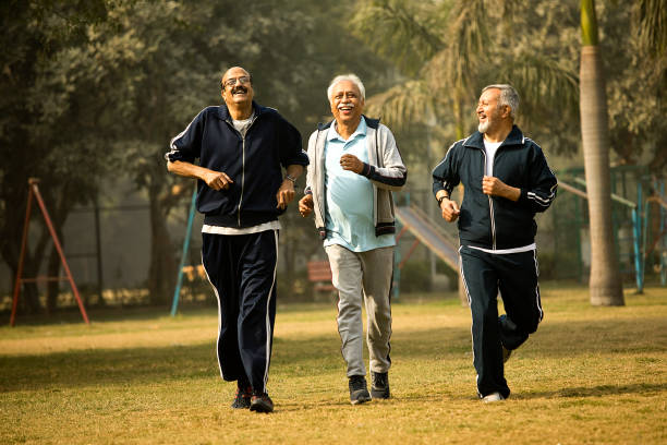 istock Cheerful old men friends running at park 1455238530