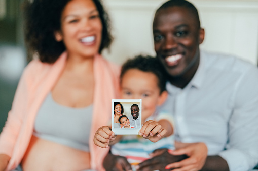 Mixed race family showing selfie photo to the camera