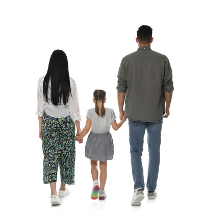 Little girl with her parents on white background, back view