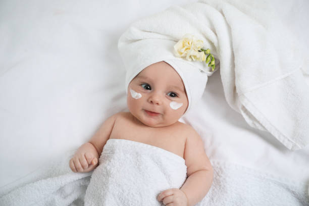 istock Cute little baby with cream on face, top view 1455239396