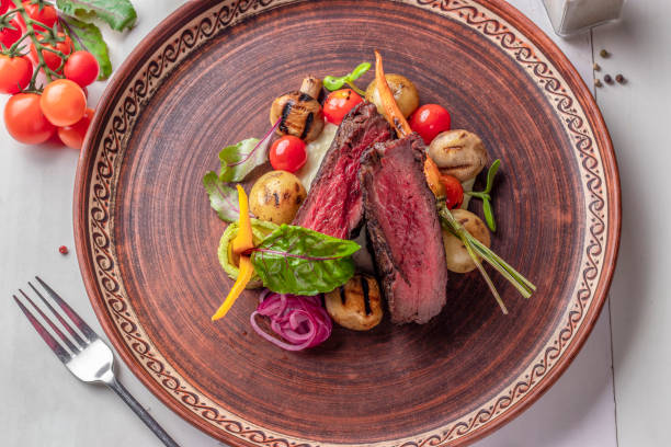 istock Filet mignon served with grilled vegetables and mushrooms, restaurant dish, Top view 1455239671