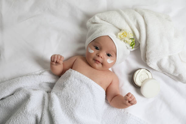 istock Cute little baby with cream on face, top view 1455240502