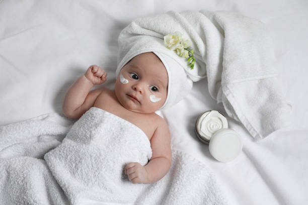 istock Cute little baby with cream on face, top view 1455240510
