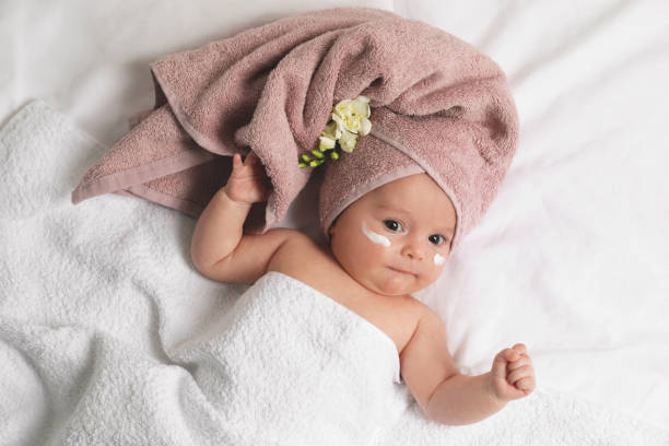 istock Cute little baby with cream on face, top view 1455240523