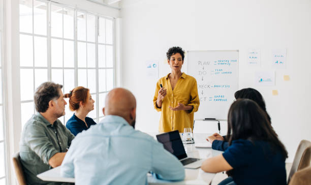 istock Black project manager having a meeting with her team in a boardroom 1455241142