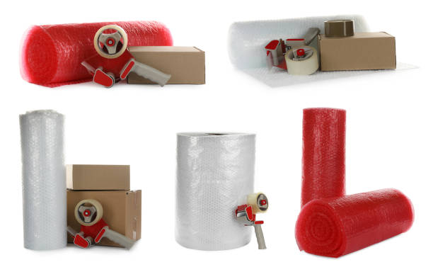 istock Set with bubble pack rolls, cardboard boxes and tape dispensers on white background 1455241999