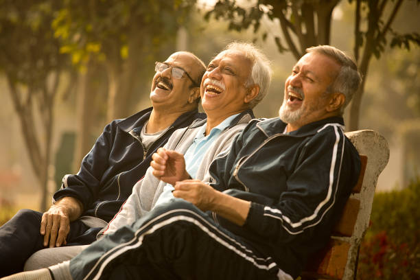 istock Old male friends laughing at park 1455243750