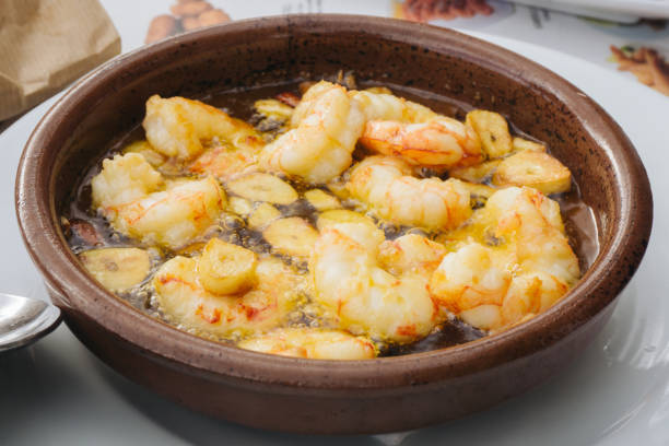 istock Shrimps in garlic dish. Restaurant meal in ceramic bowl. 1455244015
