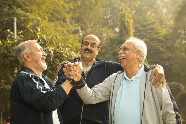 istock Old male friends laughing at park 1455244212