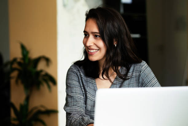 istock Young woman working on laptop in office. 1455245273