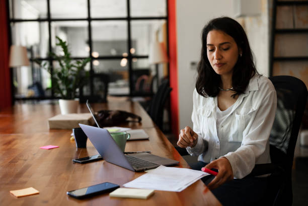 istock Young woman working on laptop in office. 1455245285