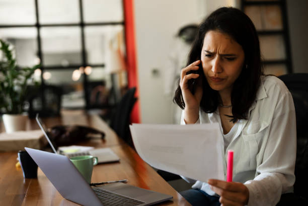 istock Young woman working on laptop in office. 1455245293