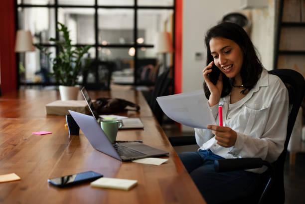istock Young woman working on laptop in office. 1455245304