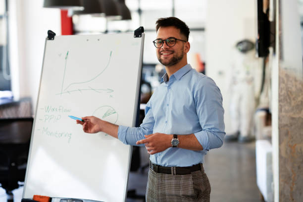 istock Young happy man presenting business plan. 1455245523