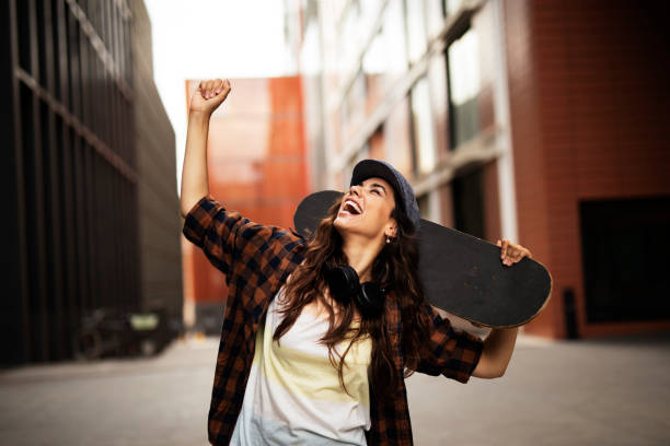 istock Beautiful young woman with a skateboard. 1455245816