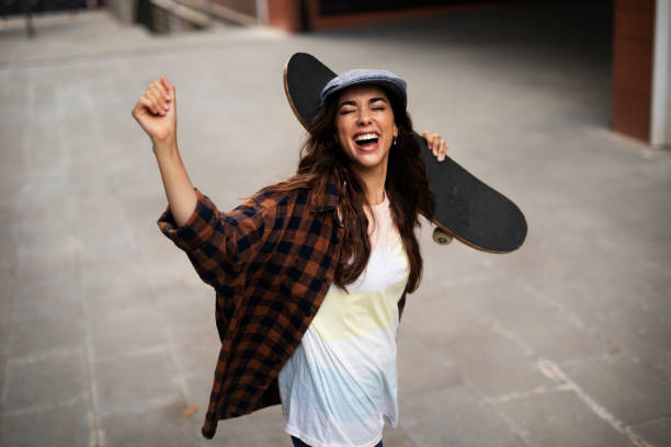 istock Beautiful young woman with a skateboard. 1455245843