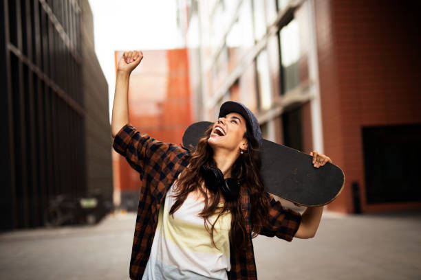 istock Beautiful young woman with a skateboard. 1455245851
