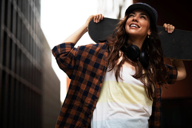 istock Beautiful young woman with a skateboard. 1455245855