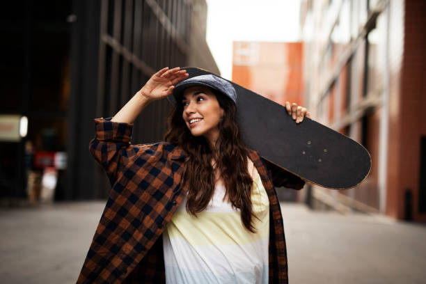 istock Beautiful young woman with a skateboard. 1455245862