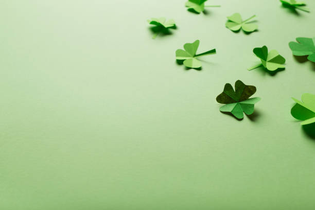 istock St. patrick's day. green background with clover leaves: shamrock and four-leafed. copy space. Paper craft 1455247744
