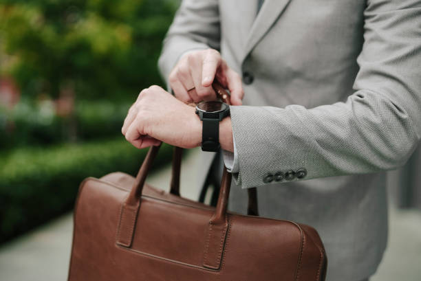 istock Handsome businessman watching at wristwatch 1455247796