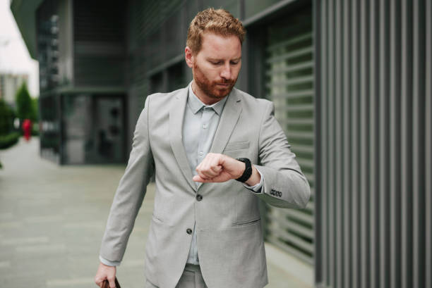 istock Handsome businessman watching at wristwatch 1455247815