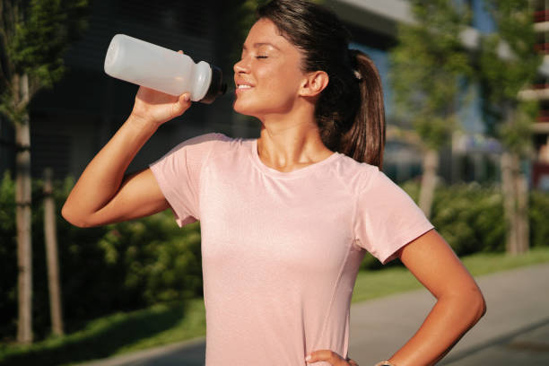 istock Thirsty woman in sportswear. 1455248569