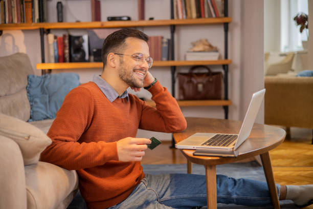 istock Man using his credit card to shop online 1455248733