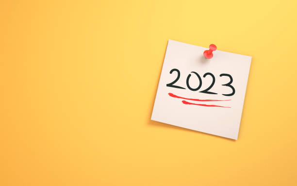 istock 2023 New Year Text Written on Note Paper Sitting on Yellow Background 1455249458
