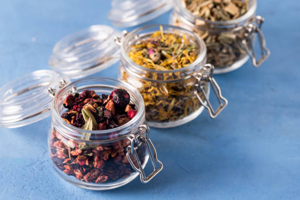 Three Jars of Different Leaf Teas on Blue Background Horizontal Above