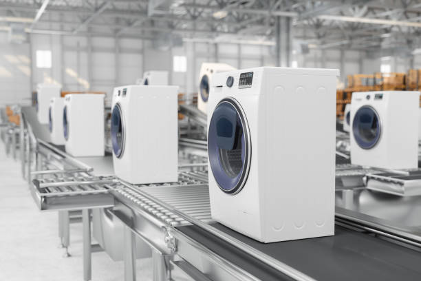 Close-up View Of Washing Machines On Conveyor Belt In Warehouse stock photo