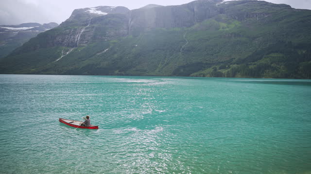 Man canoeing on the lake in Norway
