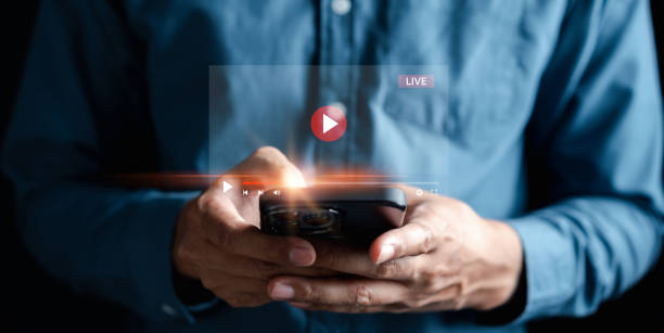 istock Man touching smartphone to starting live streaming and watching screen for video streaming on internet and multimedia, social technology, social Media, lifestyle with technology. 1455260962