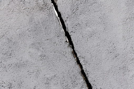 Gray concrete wall with crack.