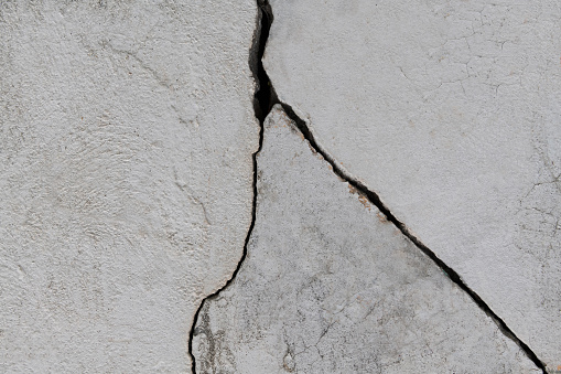 White concrete wall with crack.