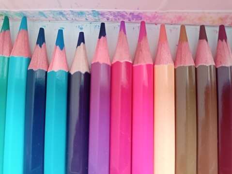 Color pencils neatly arranged in their containers and perfect color arrangements