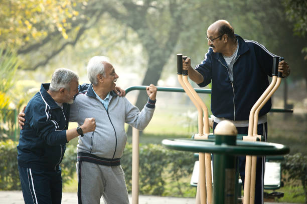 istock Friend motivating man exercising on cross trainer 1455264472