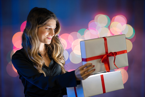 Happy Beautiful woman opening gift box