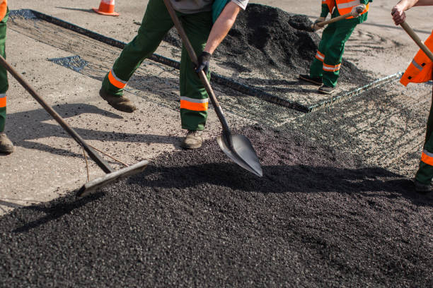 istock Builder during Asphalting road works level raw material before the operation of the machine 1455272167