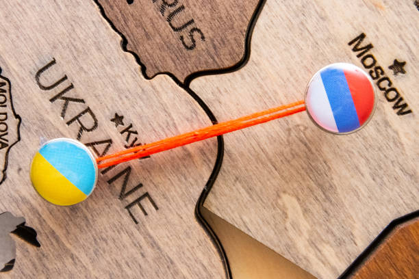 istock The confrontation between Kyiv and moscow is shown on a wooden map with red threads 1455274172