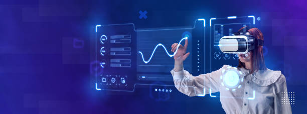 istock Woman, employee wearing VR glasses and working on virtual holographic computer screen. Launching high-technological startup 1455275401