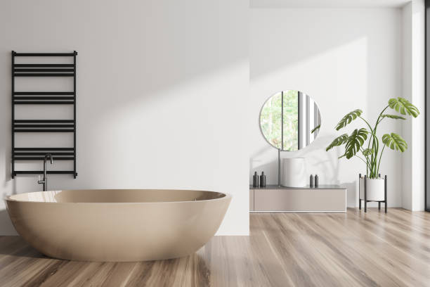 istock Front view on bright bathroom interior with bathtub, round mirror 1455275719