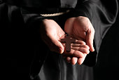 istock A monk praying with a rosary and crucifix in his hand. 1455278015