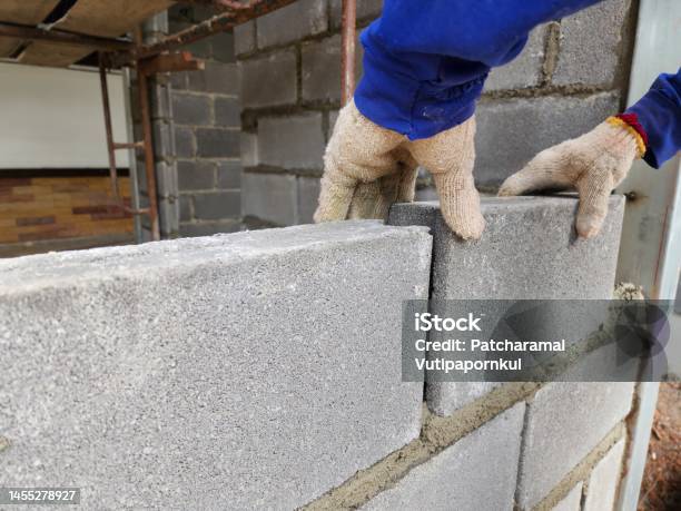 Construction Work By Putting Bricks Together And Plastering The Walls Requires Expertise Stock Photo - Download Image Now