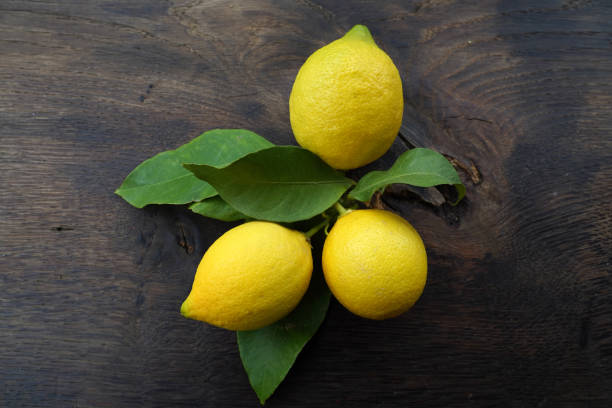 istock lemons with leaves on a wooden table 1455278963