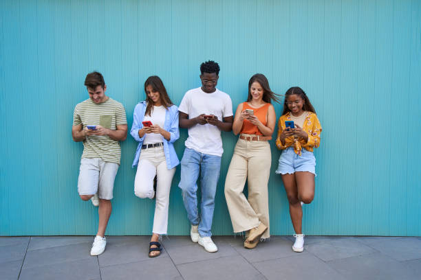 istock Multicultural group of friends using cell phones 1455279767