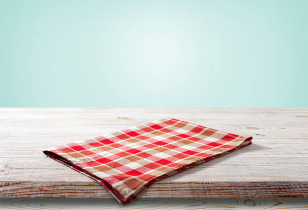 istock Blank red checkered napkin on a wooden table in perspective. 1455281366