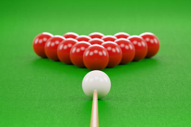 Snooker cue and pool balls over green pool table. Front view. Horizontal composition with copy space. Snooker concept.