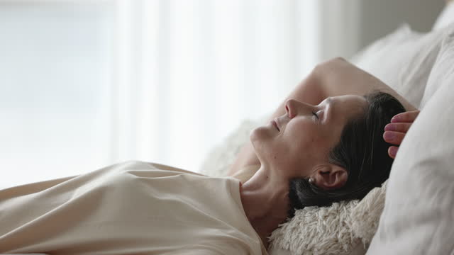 Closeup attractive mature woman sleeping resting lying on bed