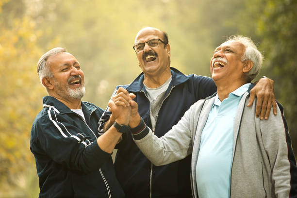 istock Old male friends laughing at park 1455283645